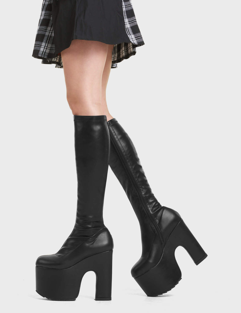 Awkward Chunky Platform Knee High Boots in Black. These knee high boots feature a chunky platform sole. Made with eco-friendly materials and 100% cruelty-free.