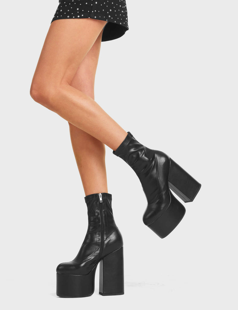 Complaints Platform Ankle Boots feature a black stretch material on the ankle.