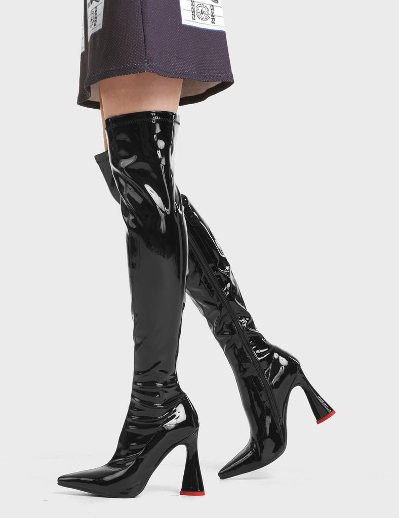 Ego Platform Thigh High Boots in Black Patent. These Thigh High Boots feature a pointed toe and a heart shaped heel.