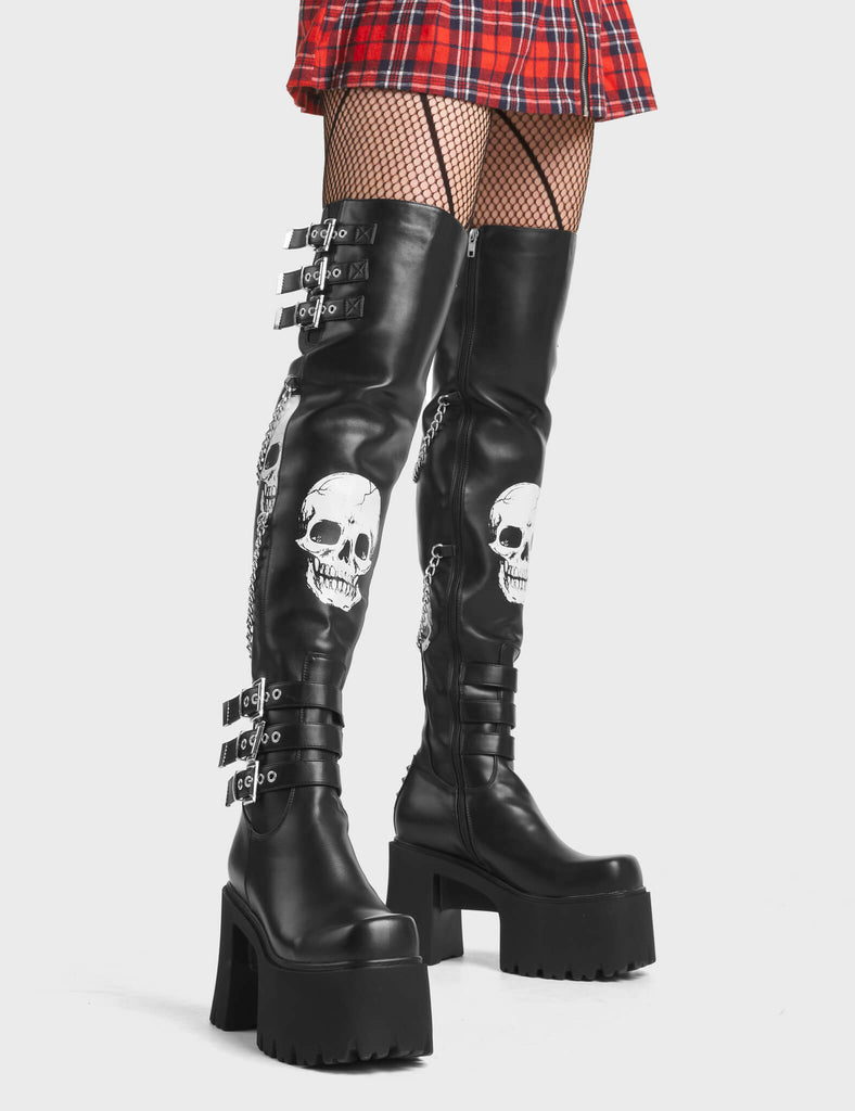 Nemesis Platform Thigh High Boots in Black. Feature skull print and adjustable straps.