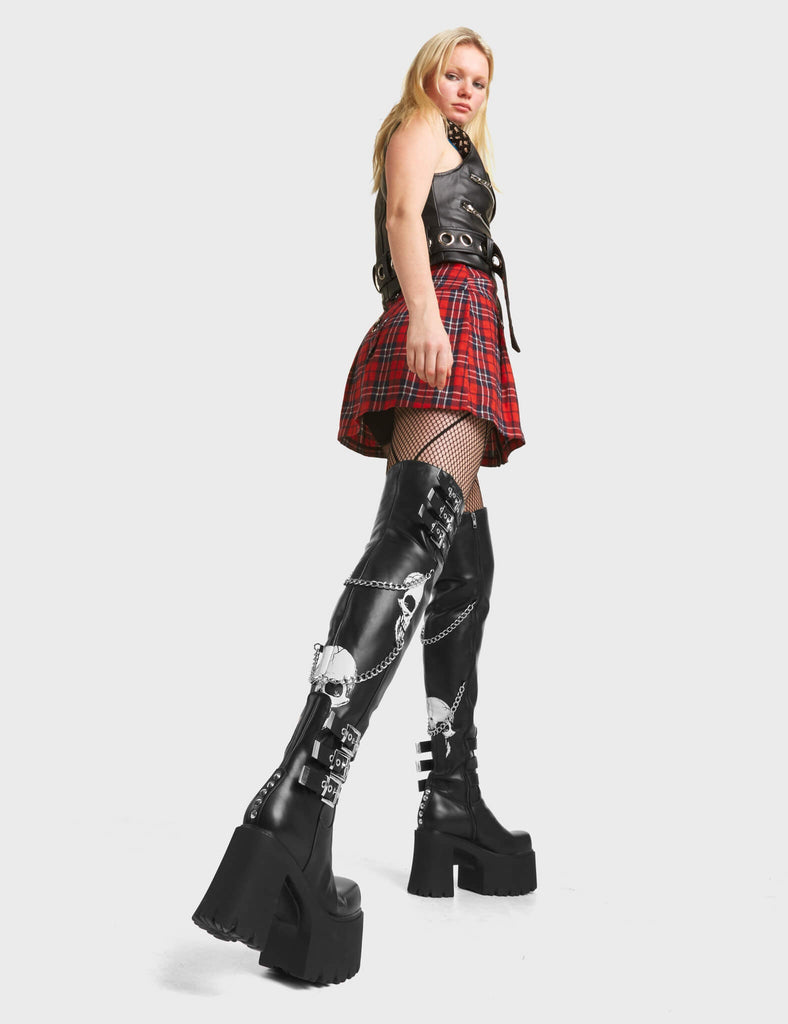 Nemesis Platform Thigh High Boots in Black. Feature skull print and adjustable straps.
